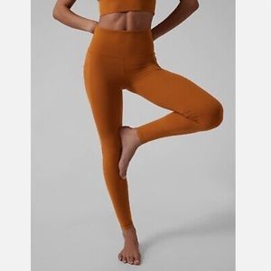 ATHLETA salutation stash pocket II tight in cattail brown